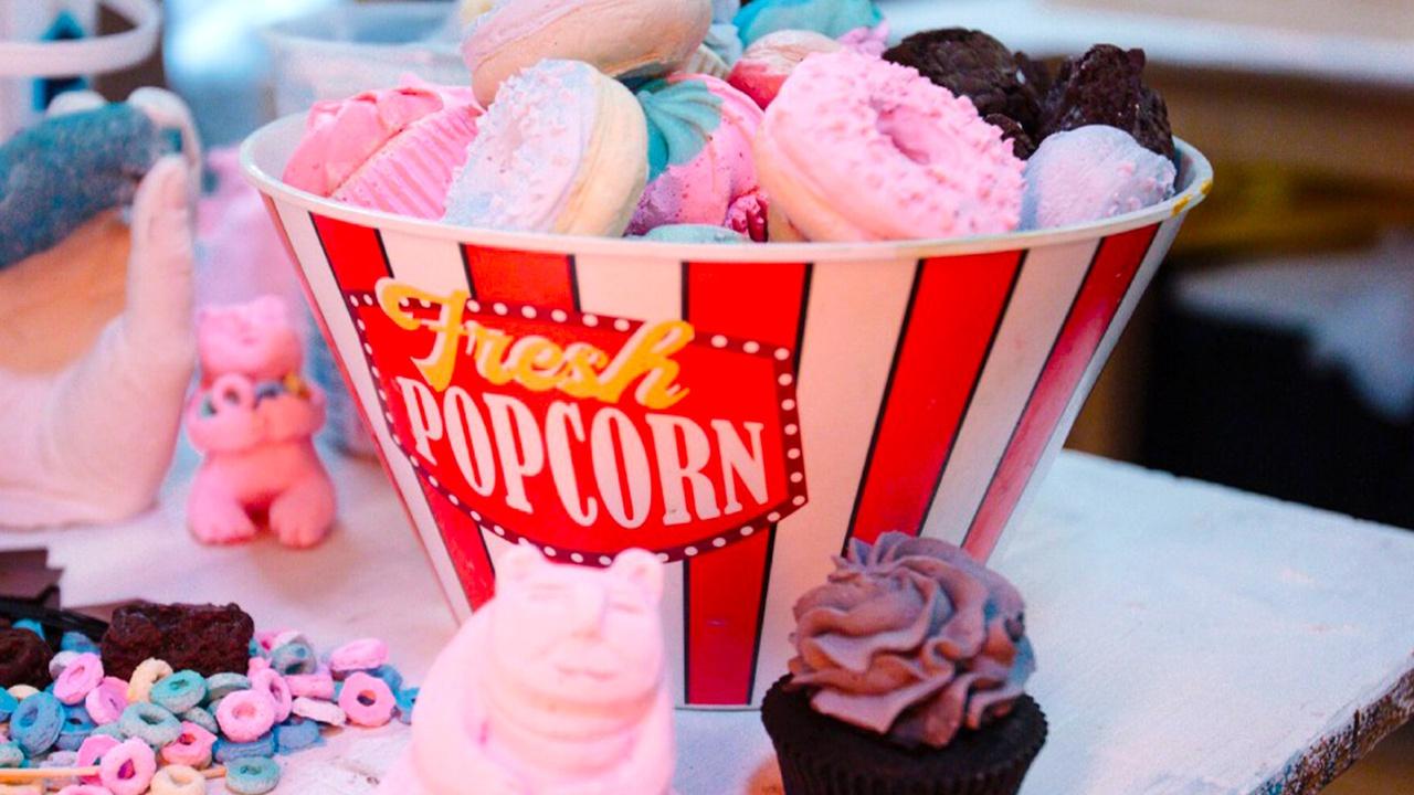 Meow Wolf popcorn bucket filled with doughnuts.