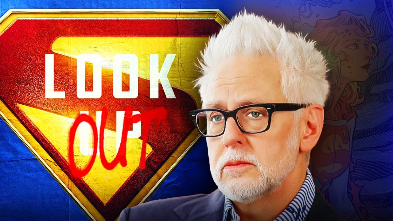 James Gunn looking at Supergirl Poster