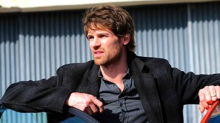 Maigret star Benjamin Wainwright leaning on a car