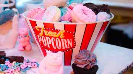 Meow Wolf popcorn bucket filled with doughnuts.