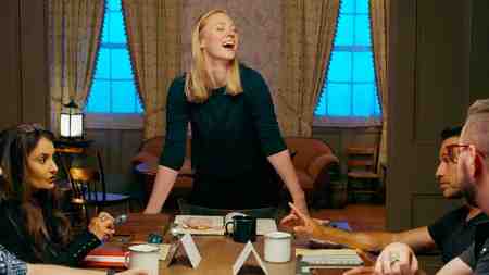 Deborah Ann Woll standing up from the table during Tales From Woodcreek.