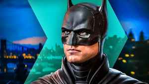 Batman, played by Robert Pattinson, with Gotham city in background.