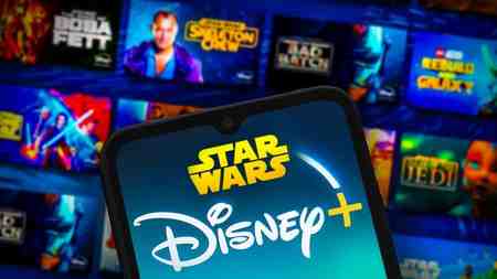 Star Wars Disney Plus app page and mobile phone with logos