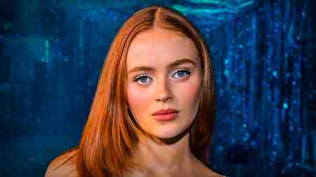 Max actress Sadie Sink on blue background.