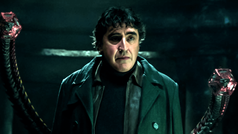 Alfred Molina as Doc Ock with arms in prison cell in Spider Man No Way Home.