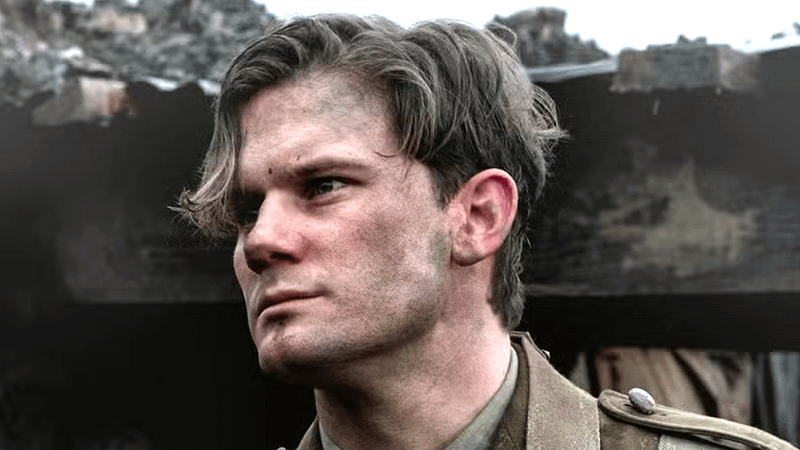 Jeremy Irvine as Henry Beauchamp standing in a trench in Outlander: Blood of my Blood