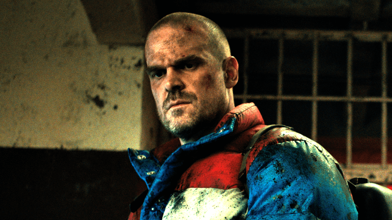 David Harbour as Jim Hopper with a shavd head in a vest in Stranger Things 5