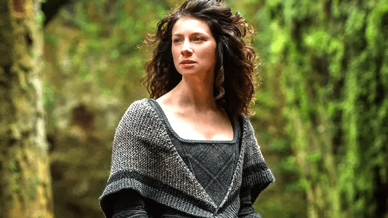 Caitriona Balfe as Claire Fraser in a forest in Outlander