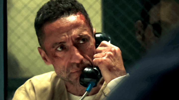 Hector Ayala talking to Matt Murdock through a phone at a prison.