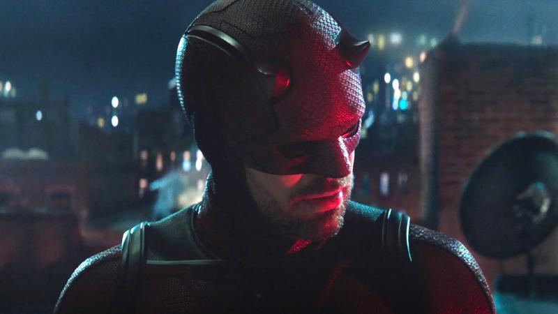 Charlie Cox as Daredevil looking over his shoulder on a dark New York City roof in Daredevil: Born Again