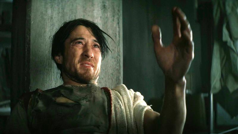 A man in a tunic reaching out his hand in Fallout