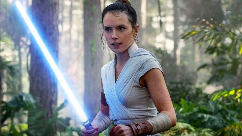 Daisy Ridley as Rey with a lightsaber in her hand in Star Wars: The Rise of Skywalker.