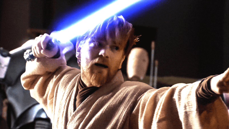 Obi Wam Kenobi wielding a blue lightsaber.
