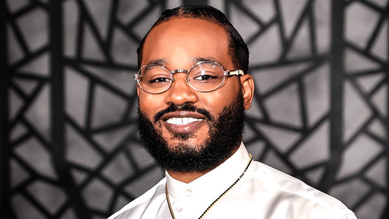 Ryan Coogler in a white dress shirt