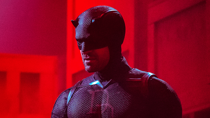 Carlie Cox as Daredevil in his mask bathed in red light in Daredevil: Born Again
