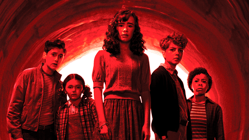 The cast of IT: Welcome to Derry standing in a red light