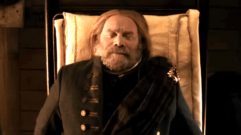 Peter Mullan as Red Jacob MacKenzie dead laying in a coffin