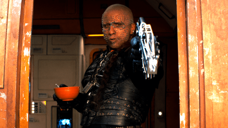 Matthias Schoenaerts as Krem of the Yellow Hills holding a bowl and a gun in 'Supergirl.' 