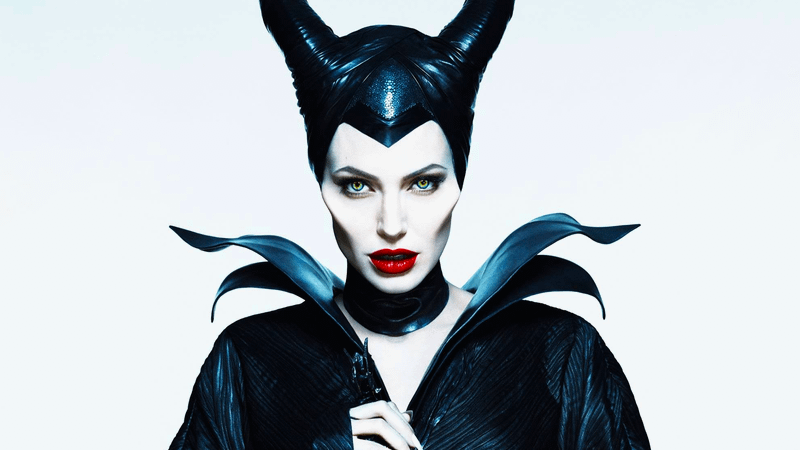 Angelina Jolie as Maleficent looking deviously at the camera in Maleficent