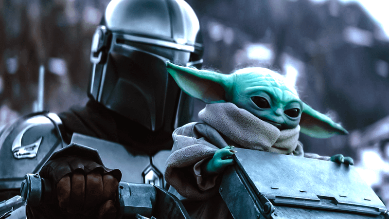 Mandalorian and Grogu on snowy planet riding AT-AT.