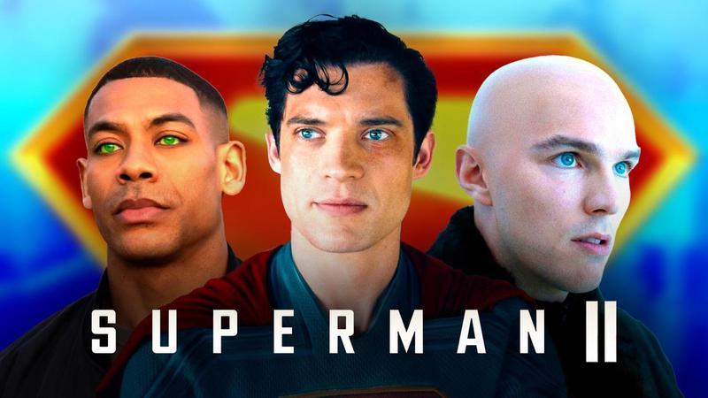 John Stewart, Superman, and Lex Luthor behind a Superman II logo.