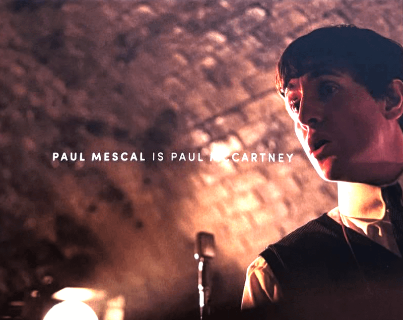 Paul Mescal as Paul McCartney singing into a microphone in The Beatles movie.