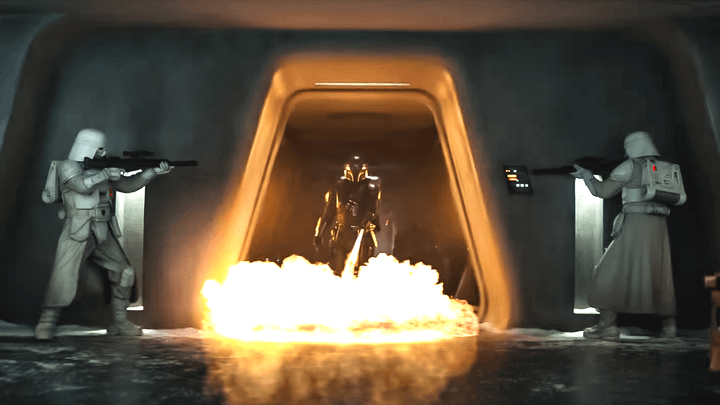 Din Djarin using his flamethrower while walking toward two snowtroopers.