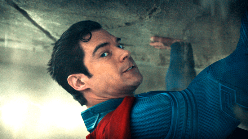 David Corenswet as Superman holding up a falling building in Superman movie