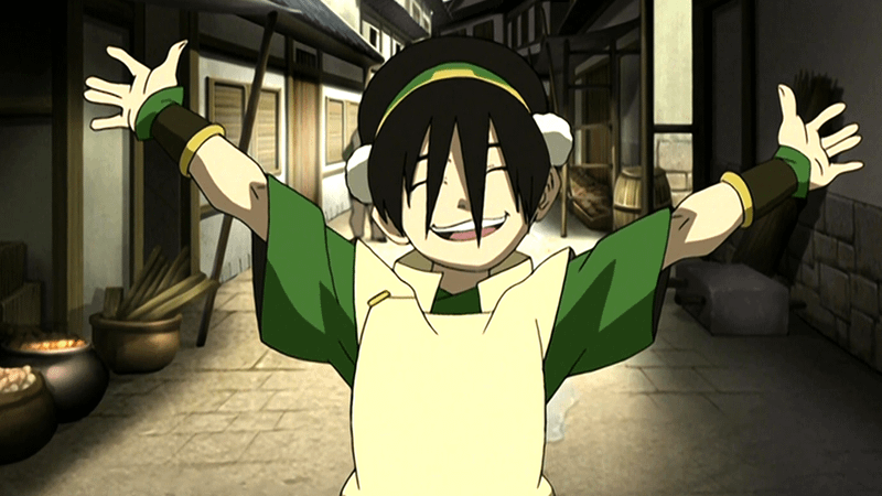 Toph with her arms wide on a city street in Avatar: The Last Airbender