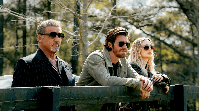 Sylvester Stallone as Dwight Manfredi, Garrett Hedlund as Mitch, & Bella Heathcote as Cleo in Tulsa King Season 3