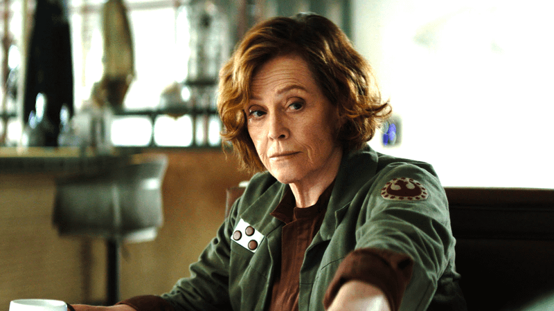 Sigourney Weaver as Ward sitting at a table in The Mandalorian & Grogu