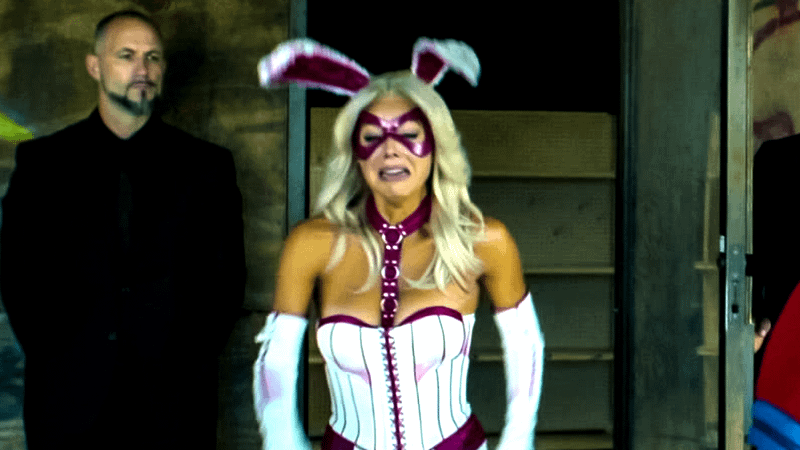 Brey Noelle as Jaina Hudson, wearing a white-and-purple suit and bunny ears, in Peacemaker.