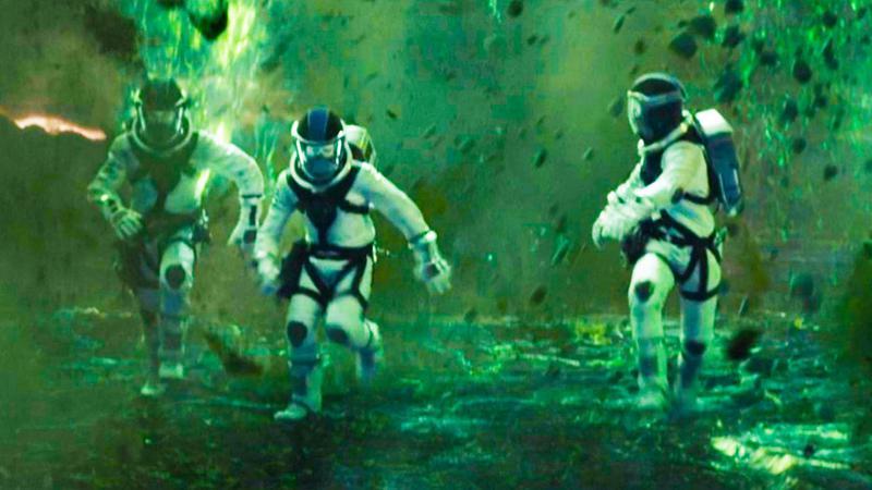Reed Richards, Ben Grimm, and Johnny Storm running away from green explosions in Fantastic Four (2015).