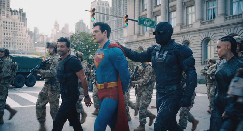 Frank Grillo (Rick Flag Sr.), David Corenswet (Superman), Ultraman, and María Gabriela de Faría (the Engineer) walking down the street in Superman 2025