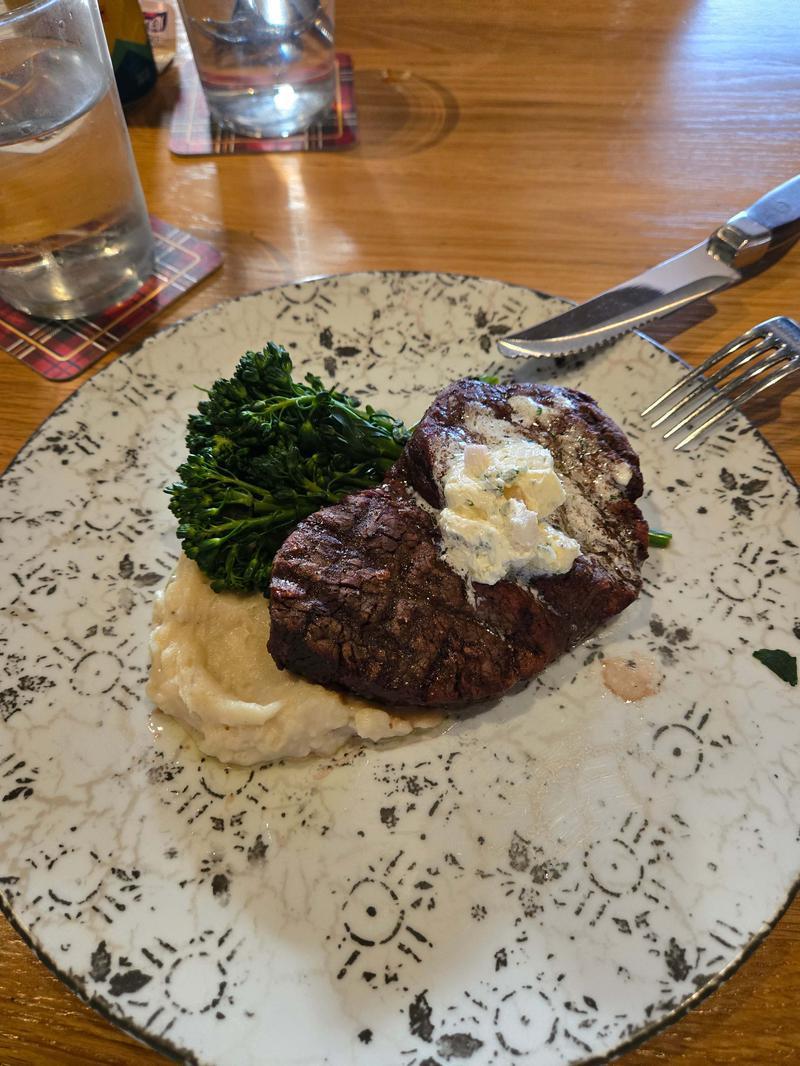A plate of filet mignon, shallot mashed potatoes, and broccolini.