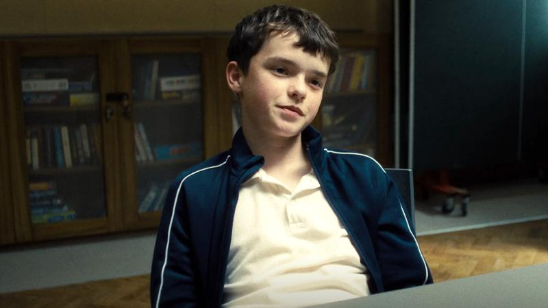 Owen Cooper sitting in a chair in Adolescence