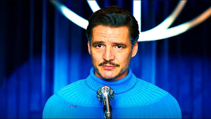 Pedro Pascal as Reed Richards standing in front of a microphone in The Fantastic Four: First Steps