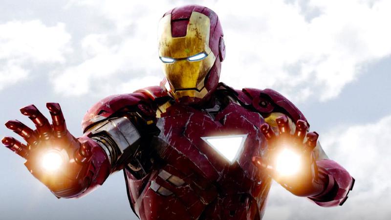 Robert Downey Jr. as Iron Man with blasters lit on his hands