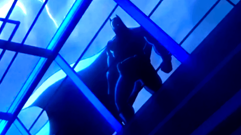 Batman seen through a window with lightning in the background in Creature Commandos
