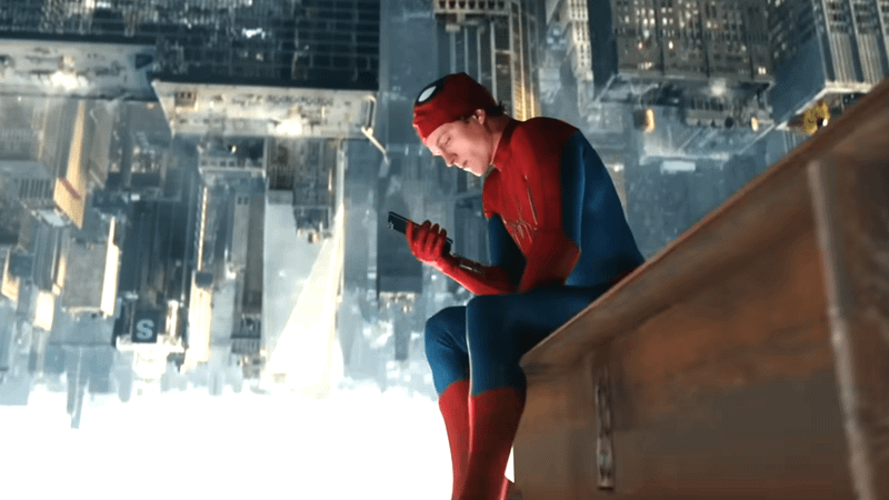 Tom Holland as Spider-Man holding his phone in 'Spider-Man: Brand New Day.'