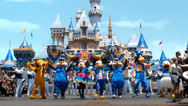 Mickey and his friends in front of the Disneyland castle.