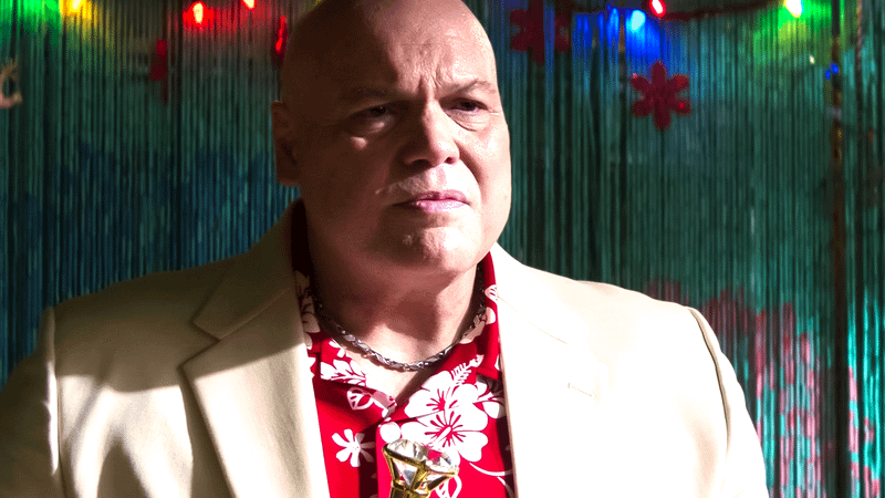 Vincent D'Onofrio's Wilson Fisk stands ominously, wearing his trademark white suit jacket and red-and-white Hawaiian shirt.