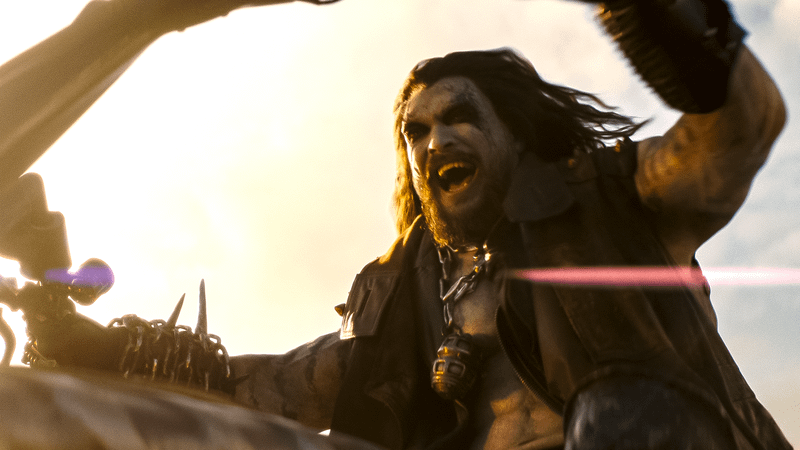 Jason Momoa as Lobo screaming and riding his bike in 'Supergirl.'