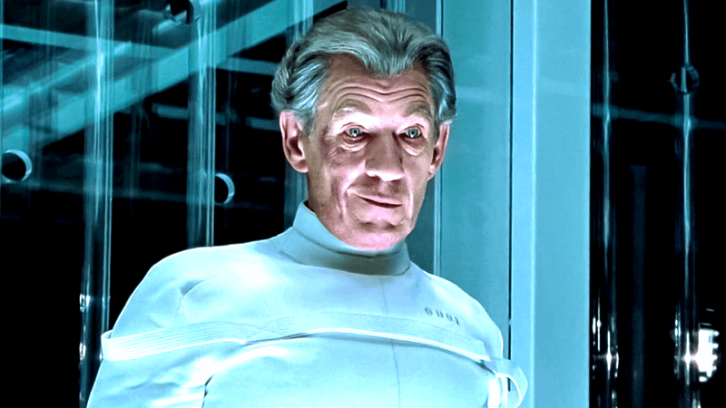 Ian McKellen as Megneto smirking in a white prisoner uniform in a plastic box in X-Men