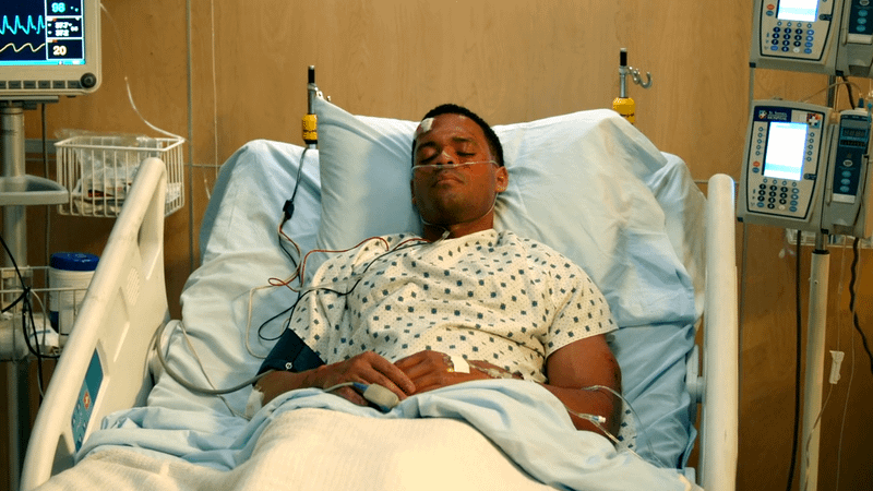 Deric Augustine as Miles Penn in the hospital in The Rookie Season 8, Episode 6.
