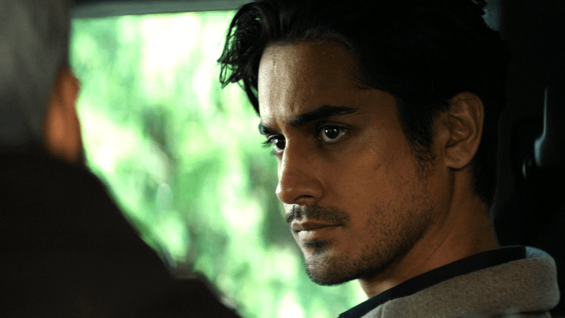 Avan Jogia as Oliver St. Ledger looking at someone in 56 Days.