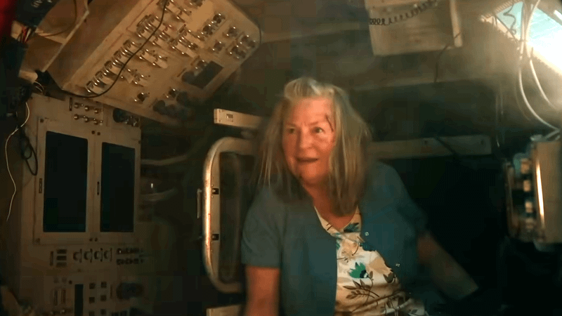 A woman under mind control inside of the tank.