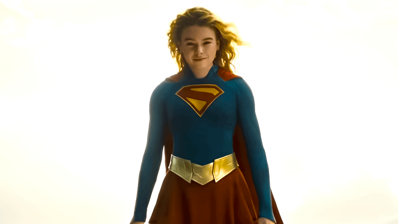 Milly Alcock flying as Supergirl in suit.