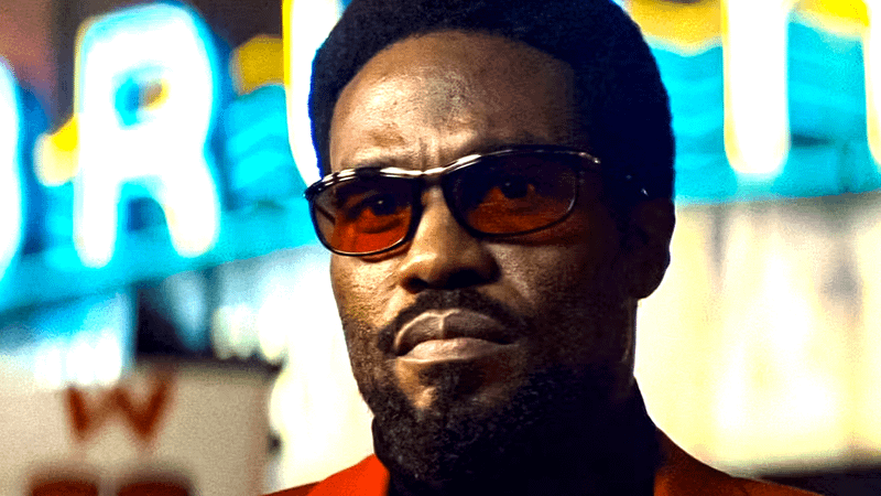 Yahya Abdul-Mateen II as Simon Williams wearing sunglasses on a lit city street in Wonder Man