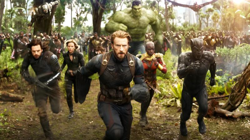 Chris Evans as Steve Rogers running with a team of Avenger behind him in Avengers: Infinity War